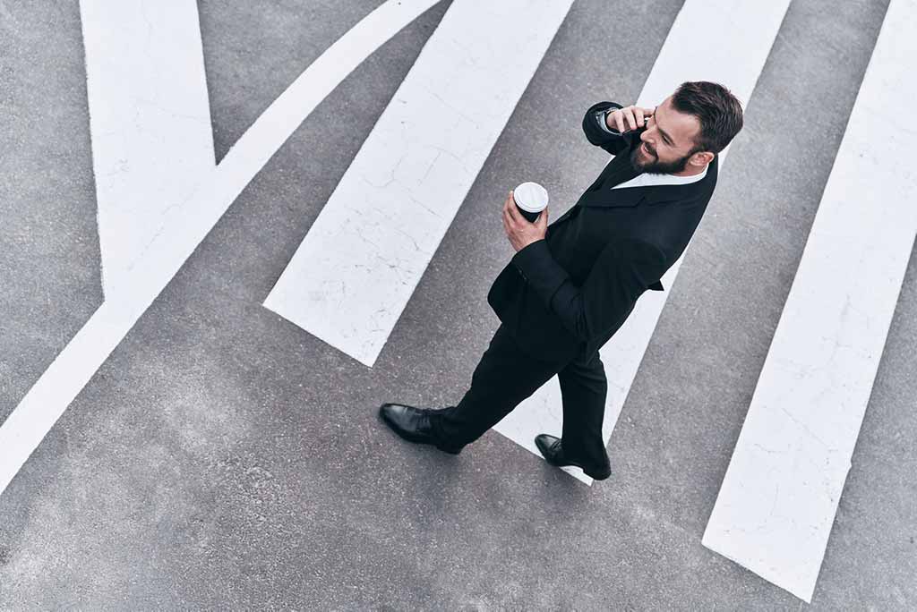 Experienced Team Business man on the phone holding coffee